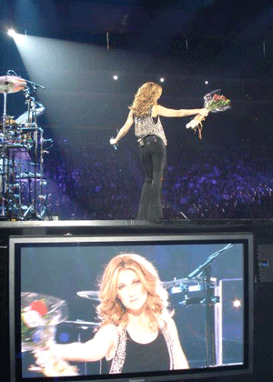 Celine Dion sings with a gift of roses from her new friend El Guapoo